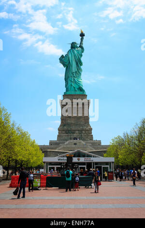 Statue of Liberty viewed from the back with tourist waiting at the entrance - May 4, 2015, Liberty Island, New York city, NY, US Stock Photo