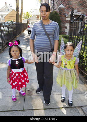 Hispanic mother with daughters dressed as Disney characters at The Ragamuffin Parade in Bay Ridge in Brooklyn, NY. Stock Photo