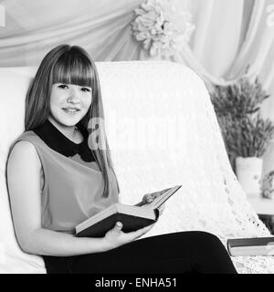 Beautiful little girl reading book Stock Photo