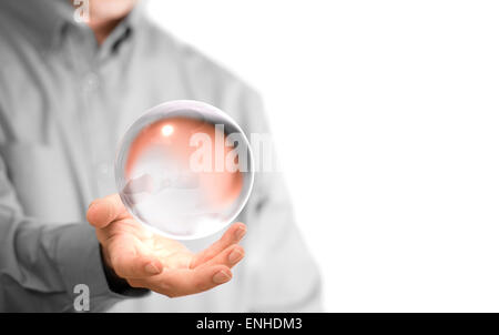 Caucasian man holding a glass or crystal ball, copy space on the left side of the image. Magician or fortuneteller background co Stock Photo