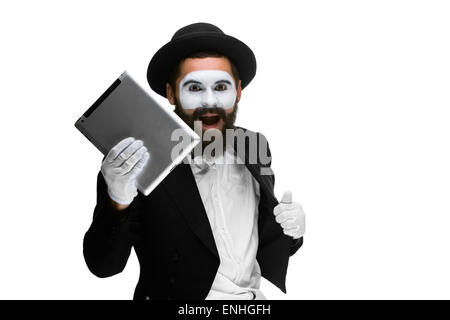 Man with  face mime working a laptop isolated on  white background. Stock Photo