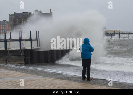 Aberystwyth, Wales, UK 6 May 2015 . A lone figure watches on Aberystwyth promenade as huge waves crash against sea defences  Credit:  Alan Hale/Alamy Live News Stock Photo