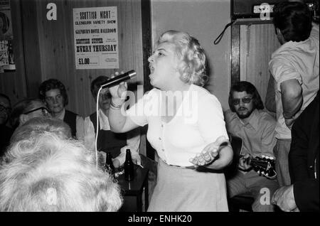 Hilda Zavaroni, mother of Lena, singing at the Athletic Bar in Rothesay, June 1974. Victor Zavaroni, Lena's father, in background playing guitar. Stock Photo