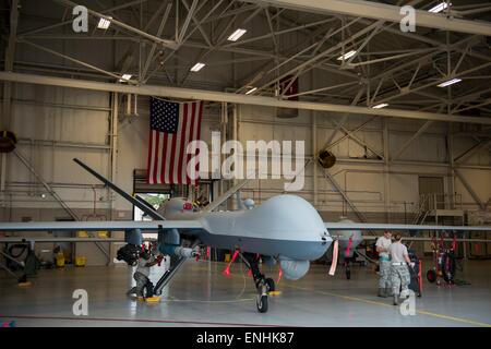 U.S. Air Force airmen with the 27th Special Operations Maintenance Squadron load munitions to an MQ-9 Reaper  UAV drone aircraft during Emerald Warrior at Hurlburt Field April 27, 2015 in Ft. Walton Beach, Florida. Stock Photo
