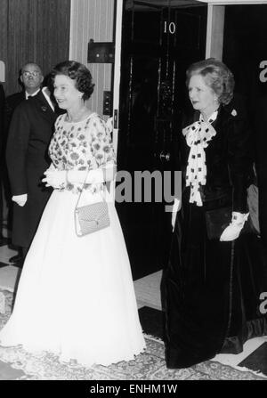The Queen is met by Prime Minister Margaret Thatcher at number 10 Downing Street for a dinner, to celebrate the 250th anniversary of the British prime minister's London residence. 4th December 1985 Stock Photo