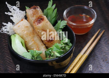 Cha Gio, Vietnamese fried spring rolls, served with chili dipping sauce Stock Photo