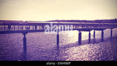 Vintage toned pier against sun, Heringsdorf in Germany. Stock Photo