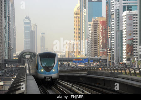 Dubai metro  train leaving station along Sheikh Zeyad Road in the United Arab Emirates Stock Photo