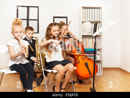 Cheerful children playing musical instruments Stock Photo