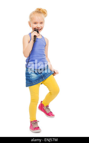 Happy girl singing in microphone and dancing Stock Photo