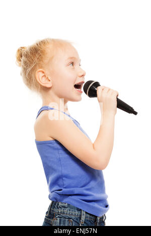 Portrait of small girl singing in microphone Stock Photo