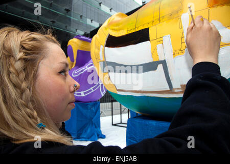 Liverpool, Merseyside, UK. 6th May, 2015. Molly Howarth painting her commissioned AquaDucks for the Riverside Festival. A team of artists is decorating a host of giant ducks,  themed on the city's history, in public view at Mann Island Development. The Liverpool Duck Trail, commissioned by AquaDucked, is to be launched on LightNight to showcase the vibrant creativity alive in Liverpool as well as to raise money and awareness for Macmillan Cancer Support. Credit:  Cernan Elias/Alamy Live News Stock Photo