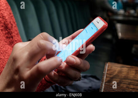 Close-up of woman organizing her diary on smart phone Stock Photo