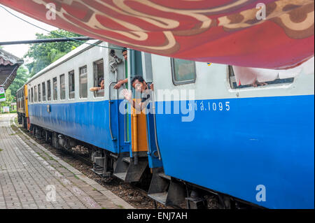 Passengers on board a train leaving River Kwai Bridge railway station. Kanchanaburi, Kanchanaburi Province, Thailand Stock Photo