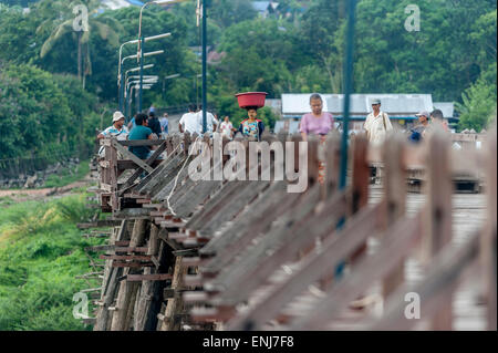 Local people crossing the rickety wooden bridge (Saphan Mon) Sangkhlaburi. Kanchanaburi Province. Thailand. Stock Photo