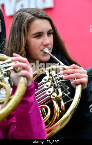 A young musician playing an French horn at the 2015 City of Derry Jazz Festival. Stock Photo