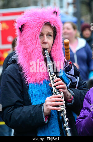 A woman in pink and blue headwear playing a clarinet at the 2015 City of Derry Jazz Festival. Stock Photo