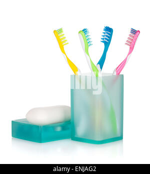 Four multicolored toothbrushes and soap. Isolated on white background Stock Photo