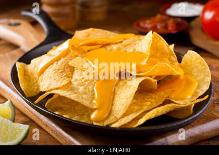 A plate of delicious plain nacho corn chips with cheese sauce. Stock Photo