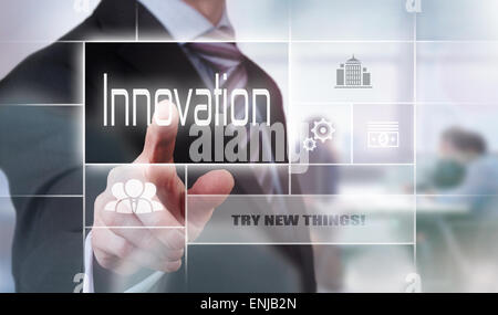 Businessman pressing an Innovation concept button. Stock Photo