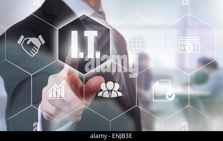 Businessman pressing an I.T. concept button. Stock Photo