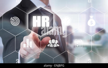 Businessman pressing a Human Resources concept button. Stock Photo