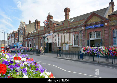 East Ham underground station entrance built on a road bridge above railway lines in East London on the District Line Stock Photo