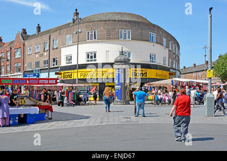 Barking town centre people shoppers in pedestrianised street scene with Albemarle & Bond pawnbroker pawn shop and market stalls East London England UK Stock Photo