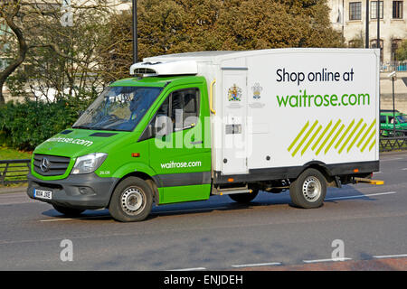 Shop online with internet being promoted on side of Waitrose delivery van alongside Royal Warrants Park Lane, Mayfair London England UK Stock Photo