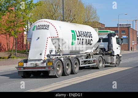 LaFarge Tarmac dry bulk cement delivery by tanker trailer lorry truck turning right into ready mix concrete plant Silvertown East London England UK Stock Photo