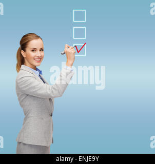 businesswoman writing something in air with marker Stock Photo