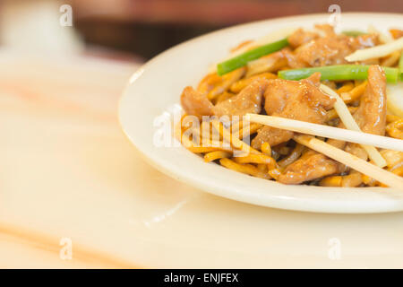 Authentic Chinese chicken lo mein noodles at a restaurant Stock Photo