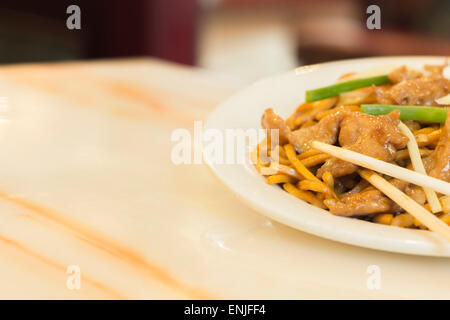 Authentic Chinese chicken lo mein noodles at a restaurant Stock Photo