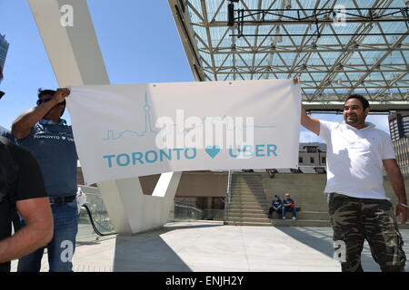 Toronto, Canada. 6th May, 2015. Nathan Phillips Square was the scene for the gathering of 100+ Uber supporters, organized in a semi-circle, chanting “Make Uber here to stay! Don’t let it go away!” and other various pro-Uber statements. Credit:  NISARGMEDIA/Alamy Live News Stock Photo