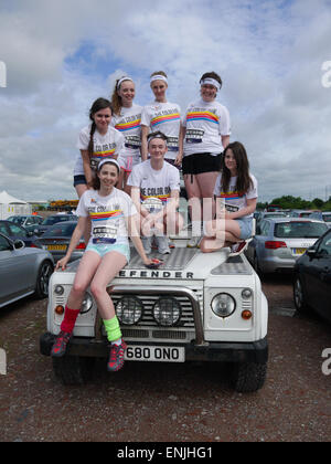 Fun runners sitting on a Land Rover before taking part in the Dulux Color Run, Manchester UK, in July 2014. Stock Photo