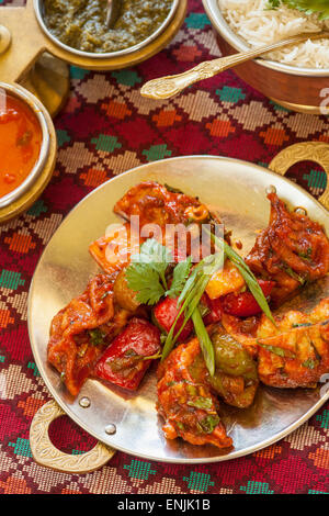 Pan fried MoMo, a type of potsticker, coated with chili sauce, Himalaya Restaurant, Cuisine of Nepal, India and Tibet, Ventura, Stock Photo