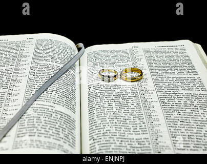 Bible Verse on Marriage with Two Wedding Rings Stock Photo