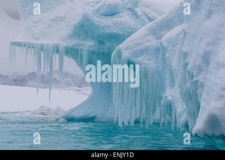 Wind and water sculpted iceberg with icicles at Booth Island, Antarctica, Polar Regions Stock Photo