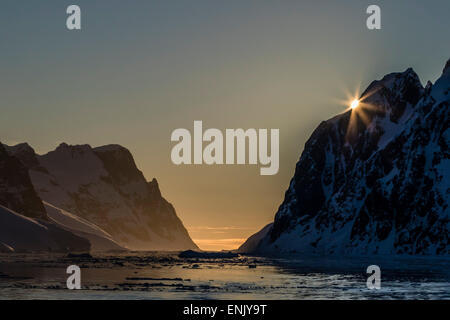 Sunset over Booth Island in the waters of the Lemaire Channel, Antarctica, Polar Regions Stock Photo