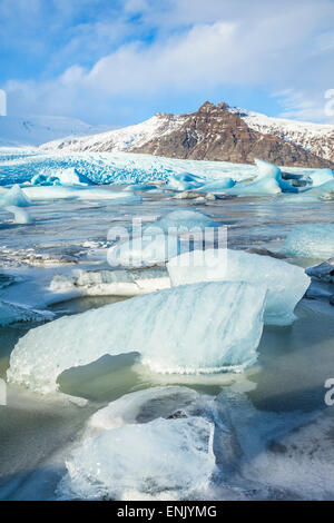 Frozen icebergs locked in the frozen waters of Fjallsarlon Glacier lagoon, South East Iceland, Iceland, Polar Regions Stock Photo