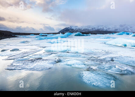 Frozen icebergs locked in the frozen waters of Fjallsarlon Glacier lagoon, South East Iceland, Iceland, Polar Regions Stock Photo