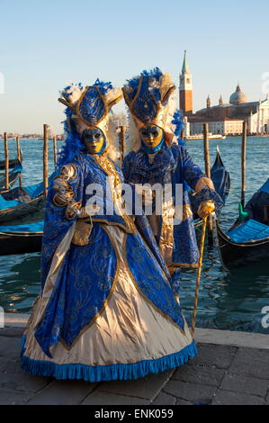 Two ladies in blue and gold masks, Venice Carnival, Venice, UNESCO World Heritage Site, Veneto, Italy, Europe Stock Photo