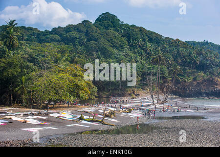 Wet clothes drying on a rocky beach, east coast of Sao Tome, Sao Tome and Principe, Atlantic Ocean, Africa Stock Photo