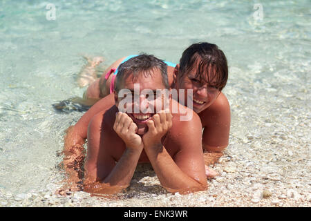 Portrait of cheerful couple in tropical sea Stock Photo