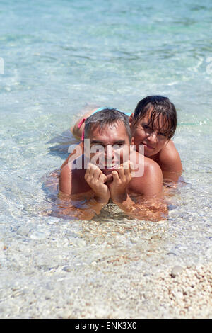 Portrait of cheerful couple in tropical sea Stock Photo