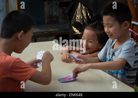 Chinese children playing cards in Shanghai, China Stock Photo