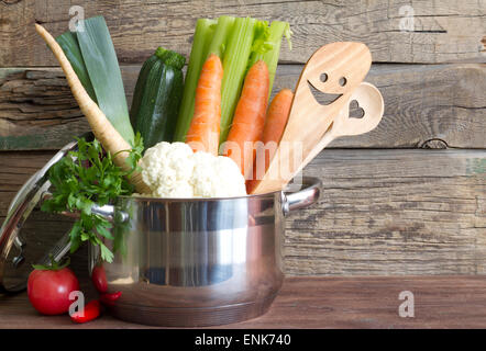 Fresh vegetables in the pot on vintage boards cooking concept Stock Photo
