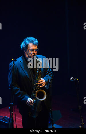 Saxophone player performing on stage during a concert Stock Photo