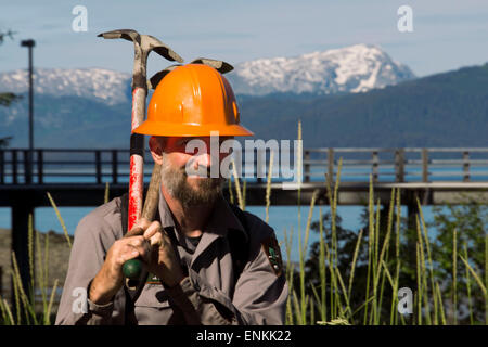 Worker in Bartlett Cove. Pier and floating dock, Bartlett Cove, Glacier Bay National Park, Alaska. Here, just 200 years ago stoo Stock Photo