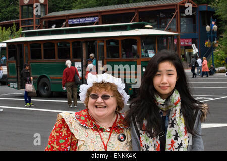 Dressed as Indians to take the photo. Juneau, Alaska. USA. Antique trolley. People getting onto the trolley bus near Mt Roberts Stock Photo